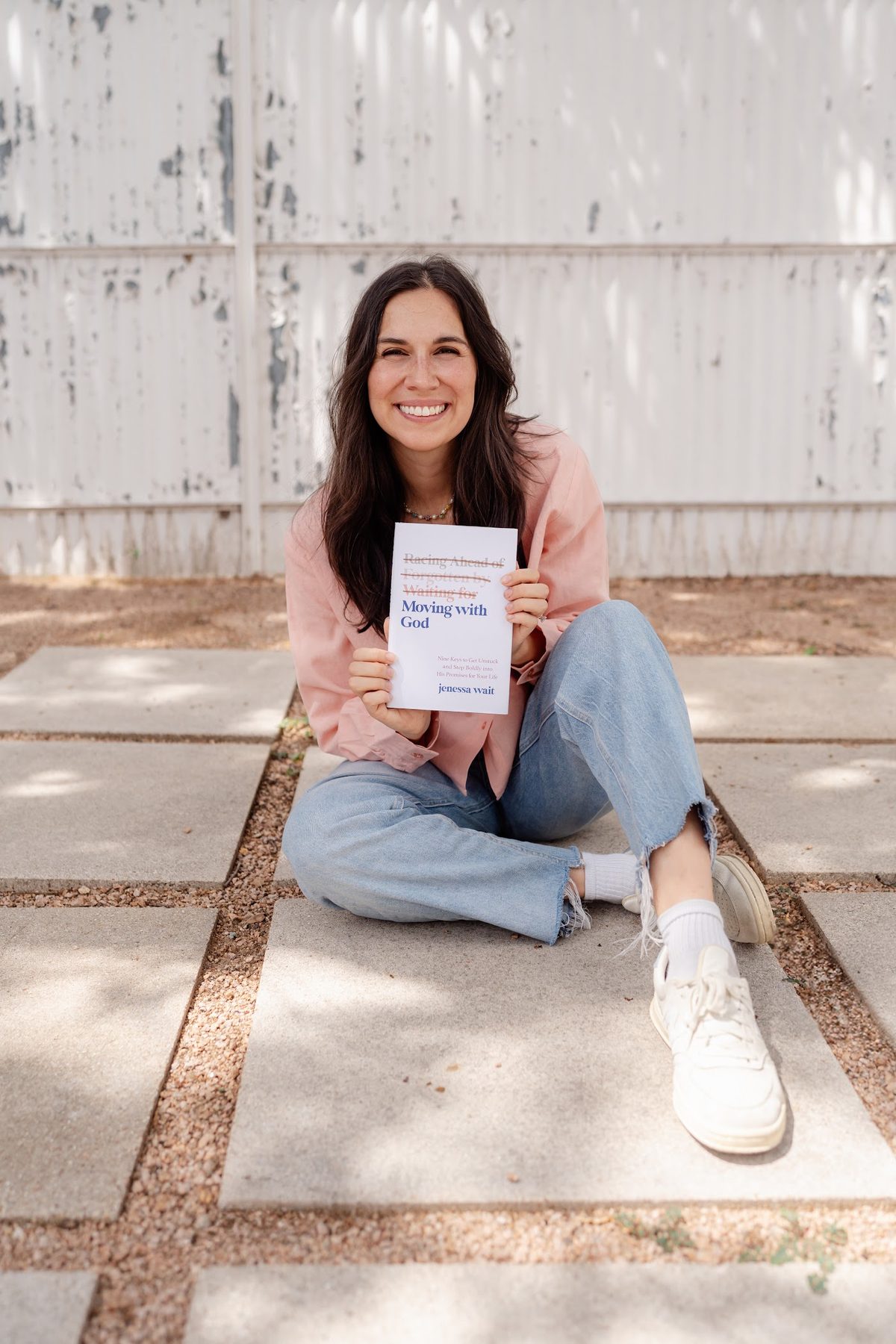 Jenessa Wait holding the Moving with God book
