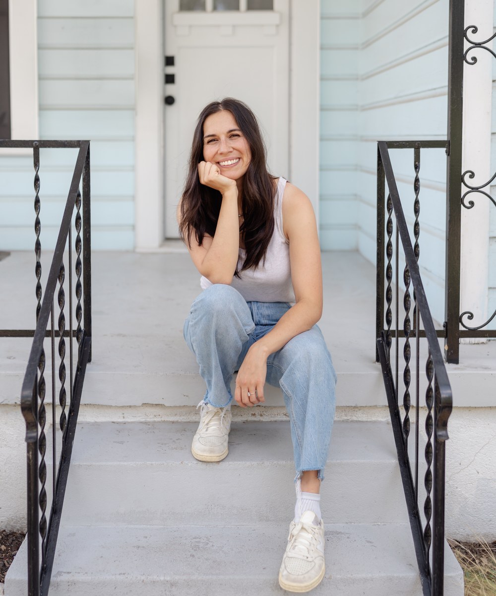 Jenessa Wait sitting on the front steps of a house